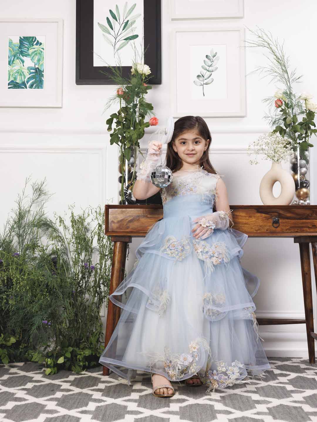 Daphne blue and white layered gown with flowers and feathers detailing Daphne blue and white layered gown with flowers and feathers detailing