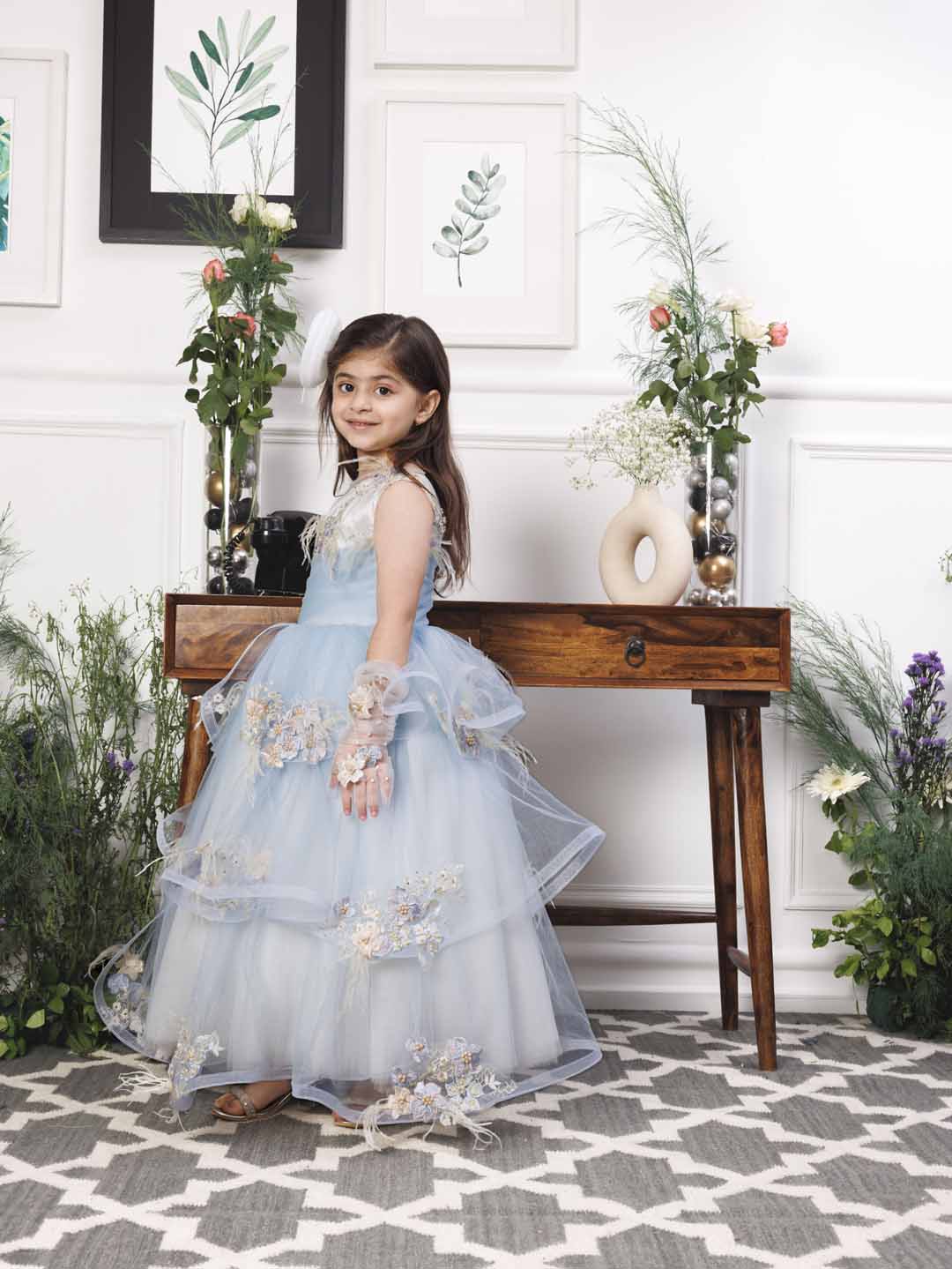 Daphne blue and white layered gown with flowers and feathers detailing