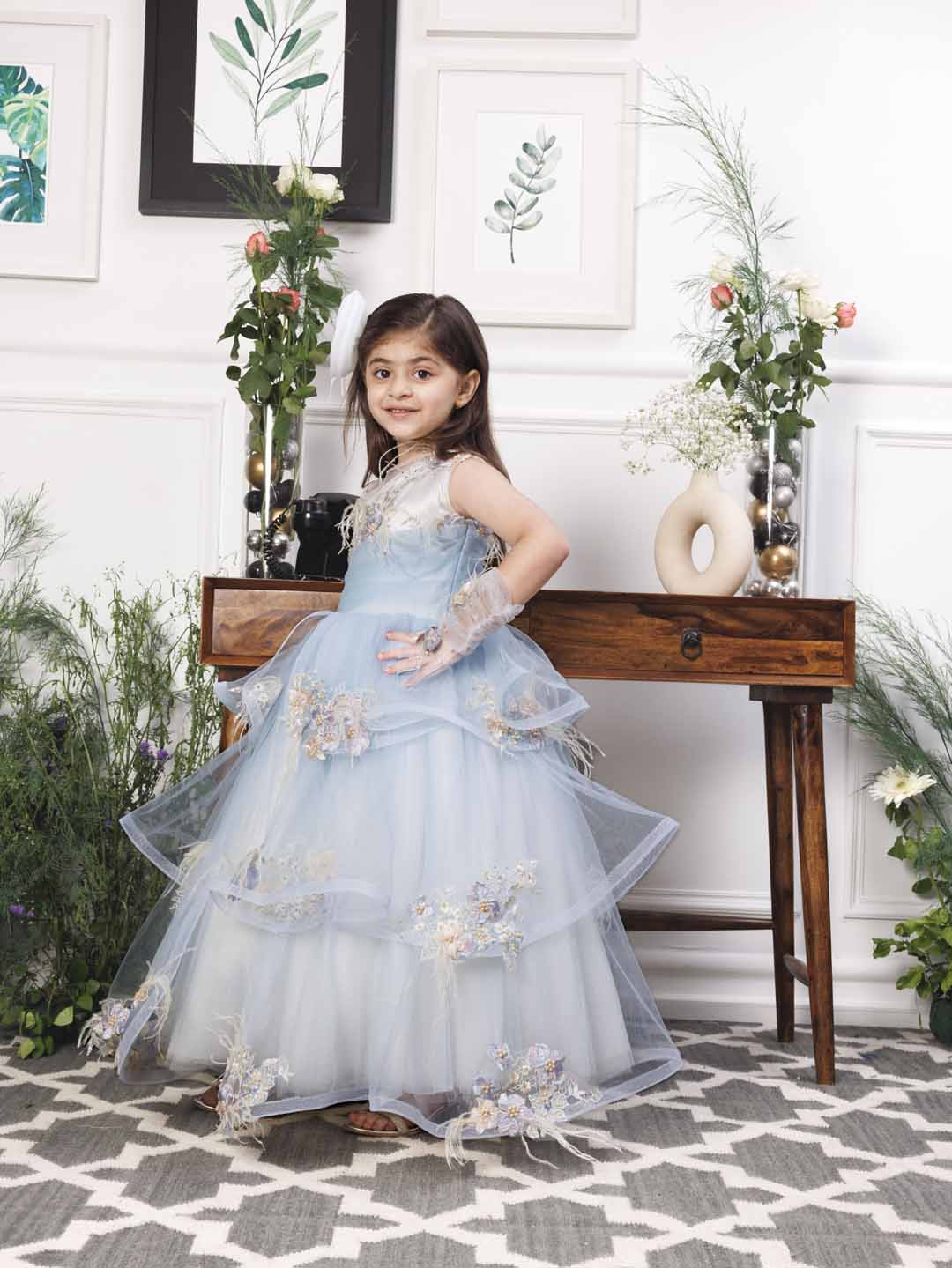 Daphne blue and white layered gown with flowers and feathers detailing