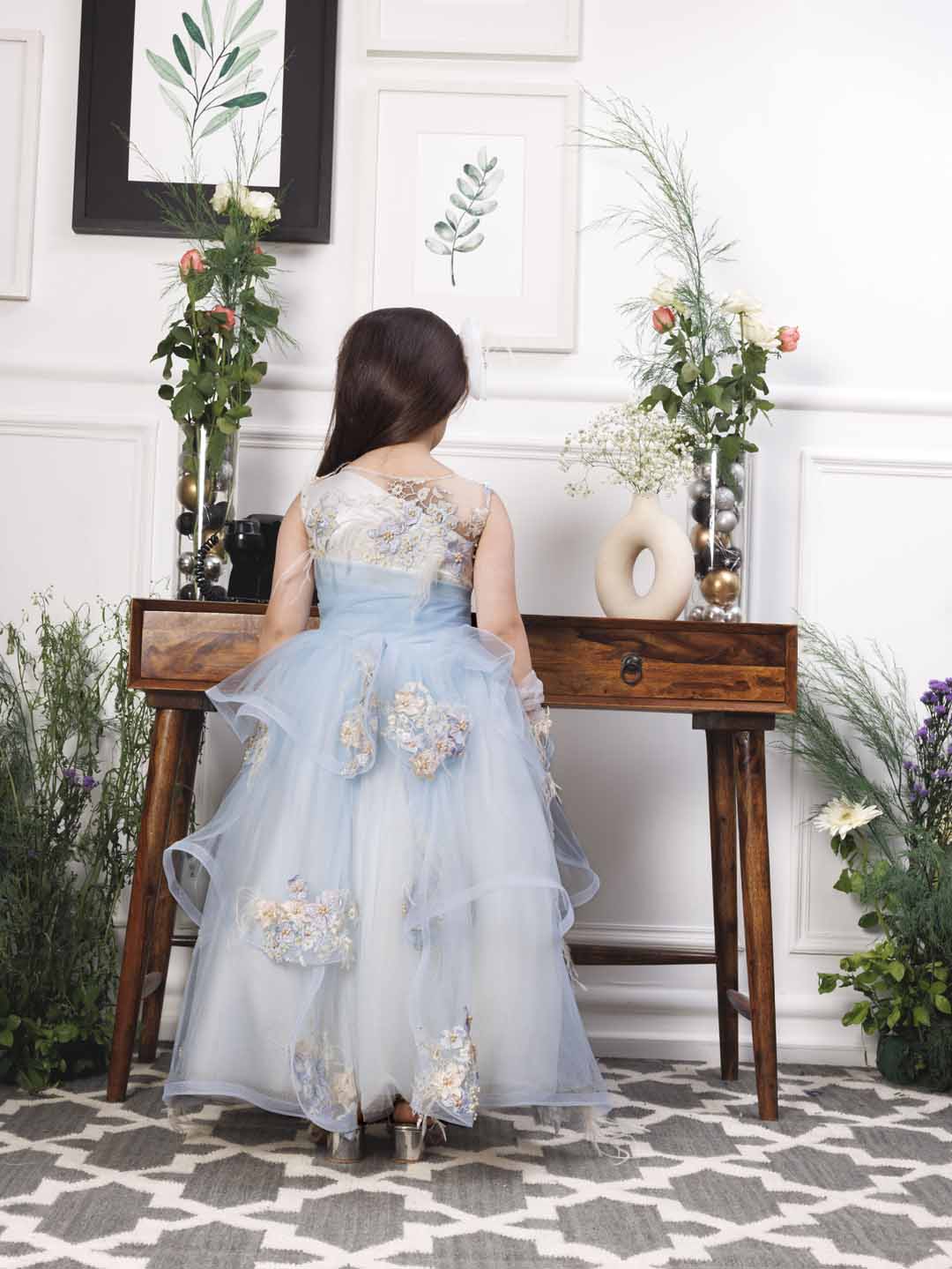 Daphne blue and white layered gown with flowers and feathers detailing