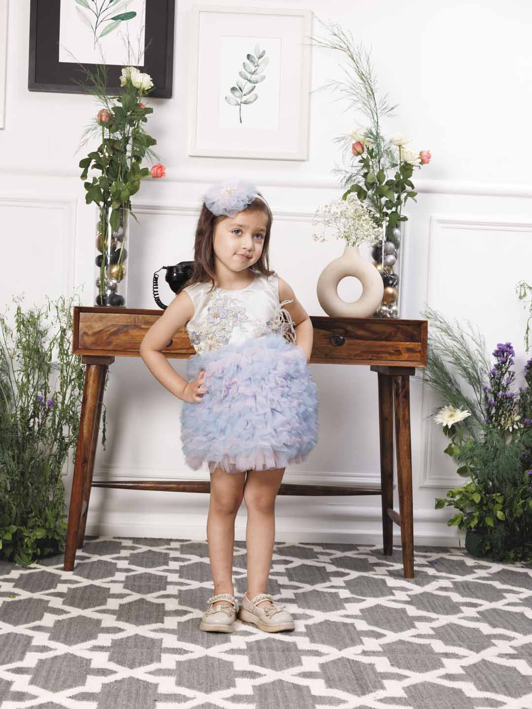 Aida ruffled pink and blue dress with flower and feathers detailing