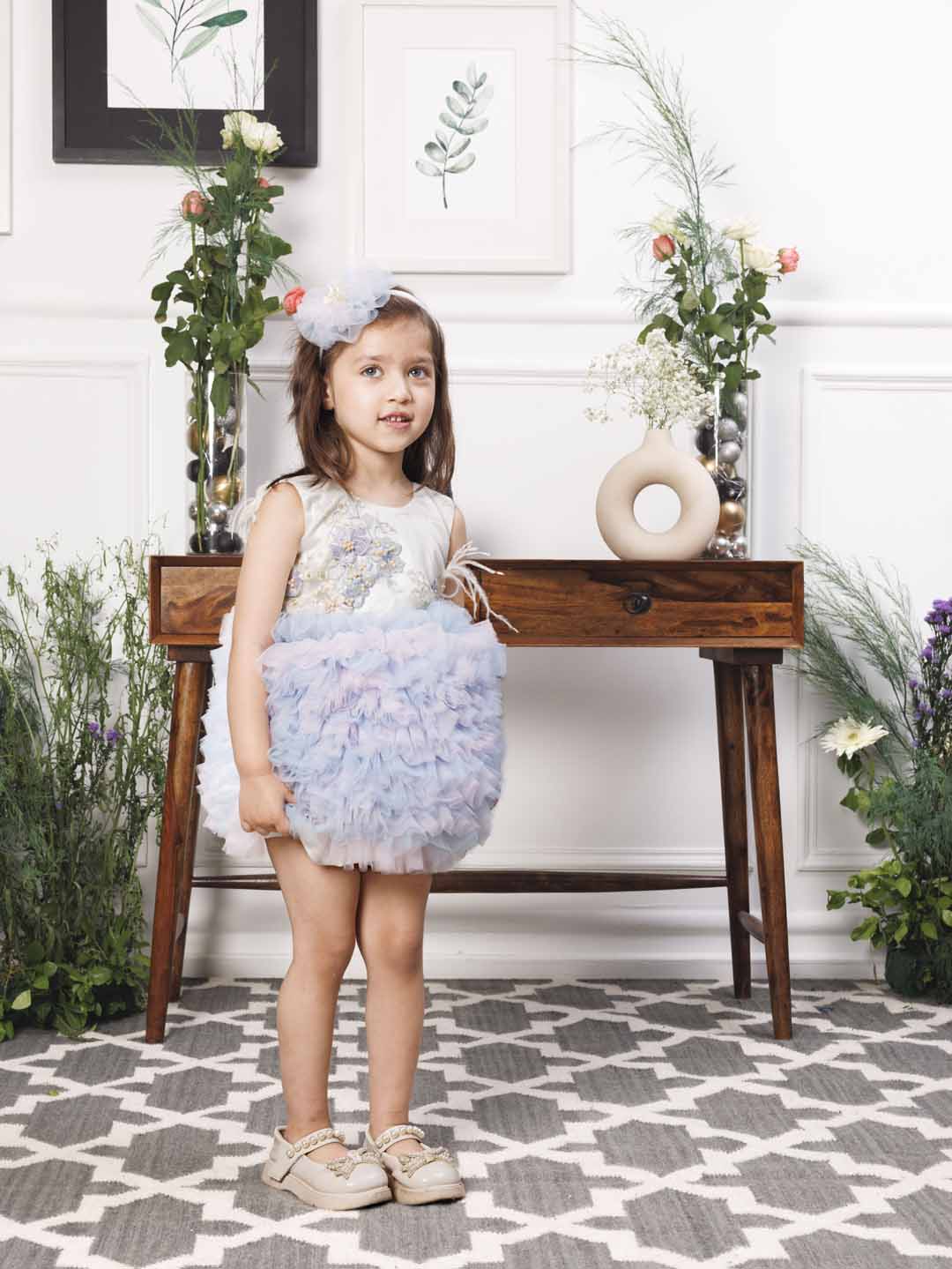 Aida ruffled pink and blue dress with flower and feathers detailing