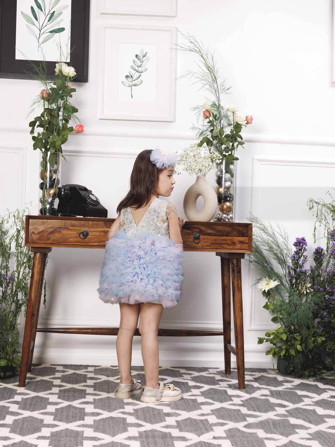 Aida ruffled pink and blue dress with flower and feathers detailing