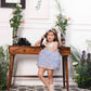 Aida ruffled pink and blue dress with flower and feathers detailing