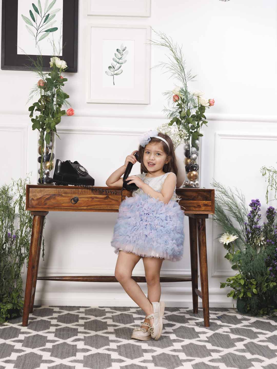 Aida ruffled pink and blue dress with flower and feathers detailing