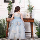 Daphne blue and white layered gown with flowers and feathers detailing